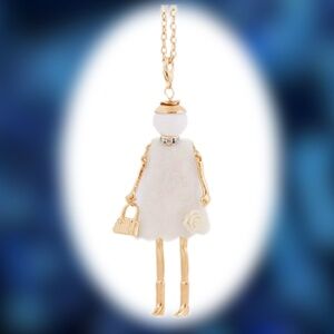 Doll Necklace On Long Chain White Dress With White Flower Lower Front Of Dress